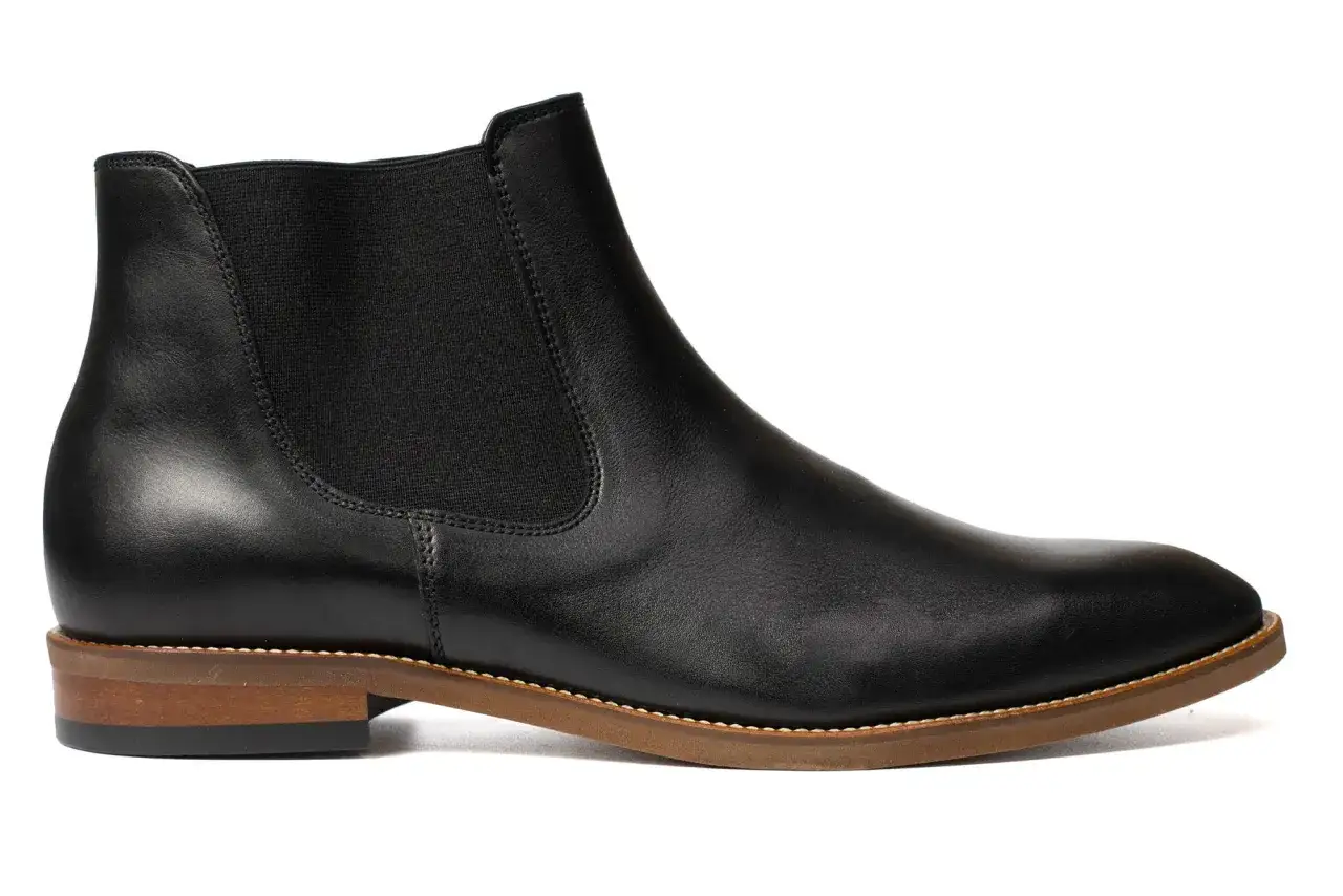 Eleganckie, czarne buty zimowe do garnituru, wykonane ze skóry, z elastycznymi wstawkami po bokach.